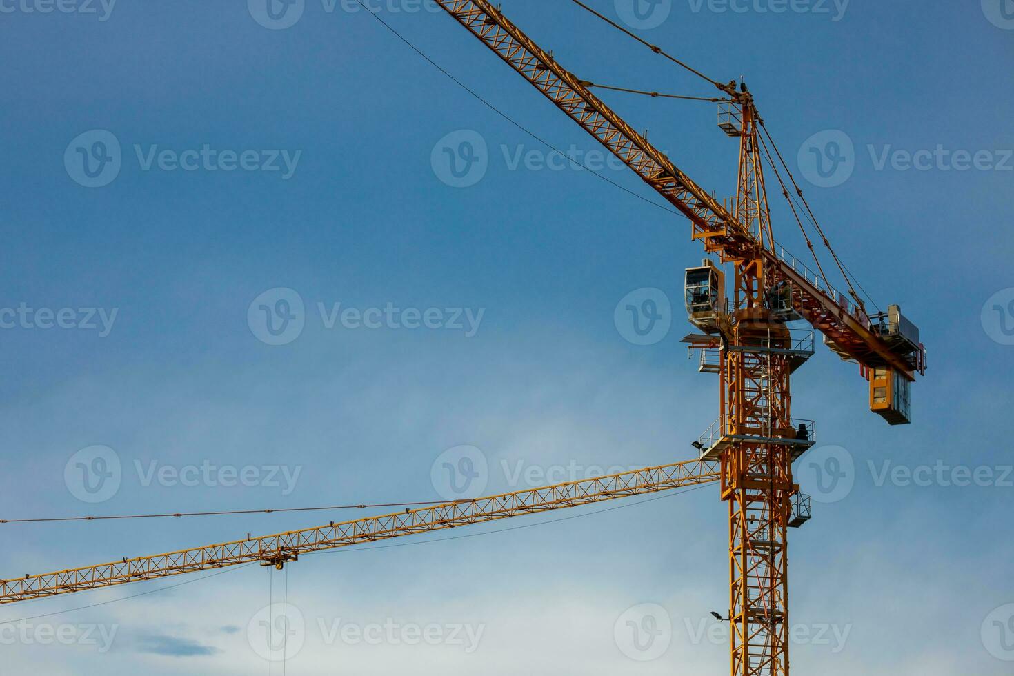 cranes working on a building construction site photo