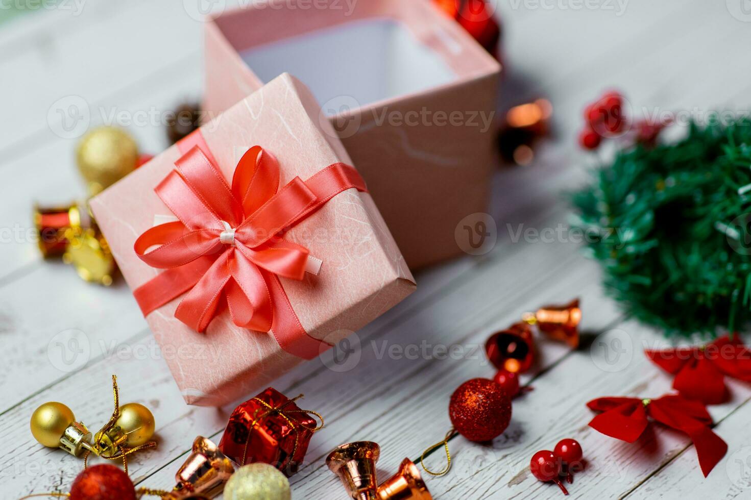 Closeup of pink gift box and Christmas composition on a wood background. Layout Christmas background concept. photo