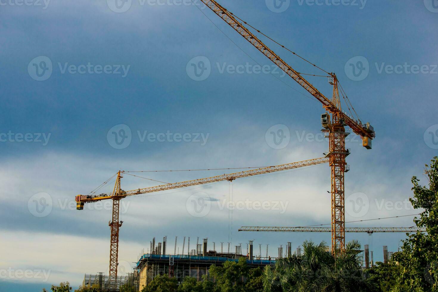 cranes working on a building construction site photo