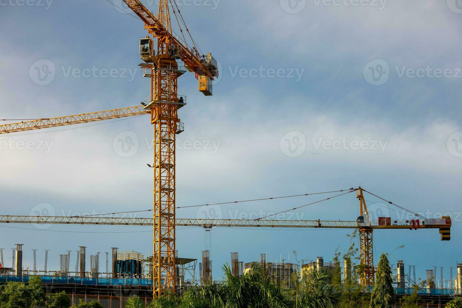 cranes working on a building construction site photo