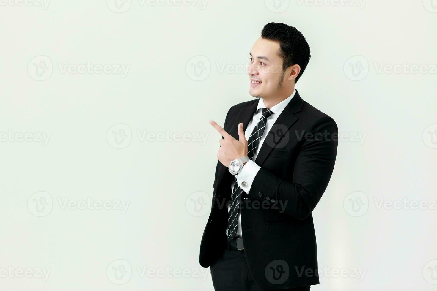 Business Asian man pointing fingers away at copy space isolated on white background photo