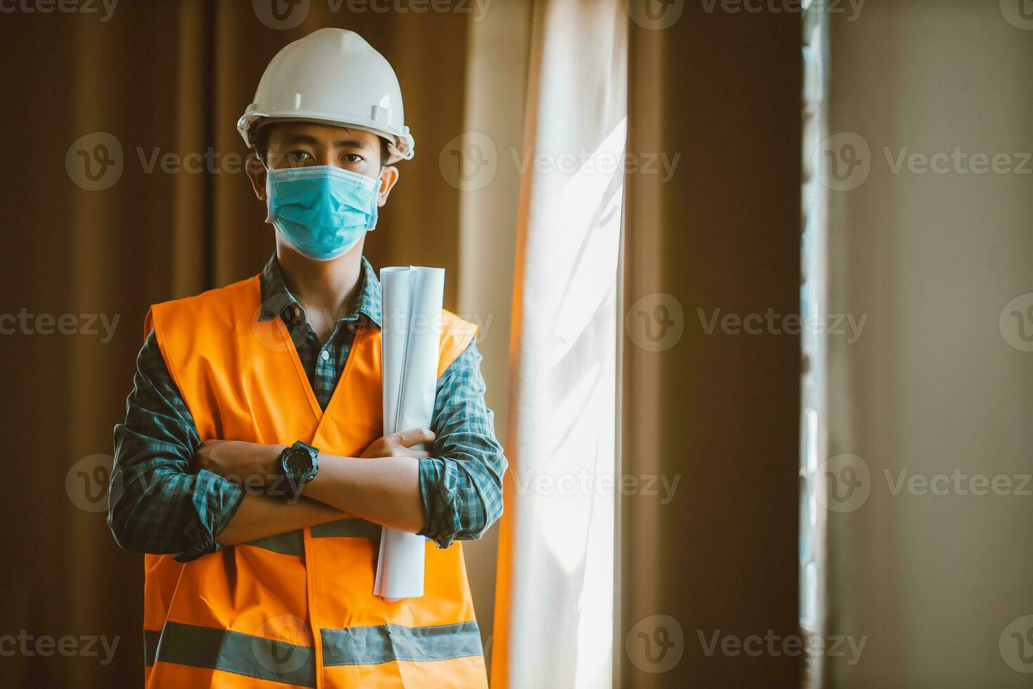 Portrait of industrial engineer man wears protective mask in office for prevention COVID-19 virus to stop spreading. photo