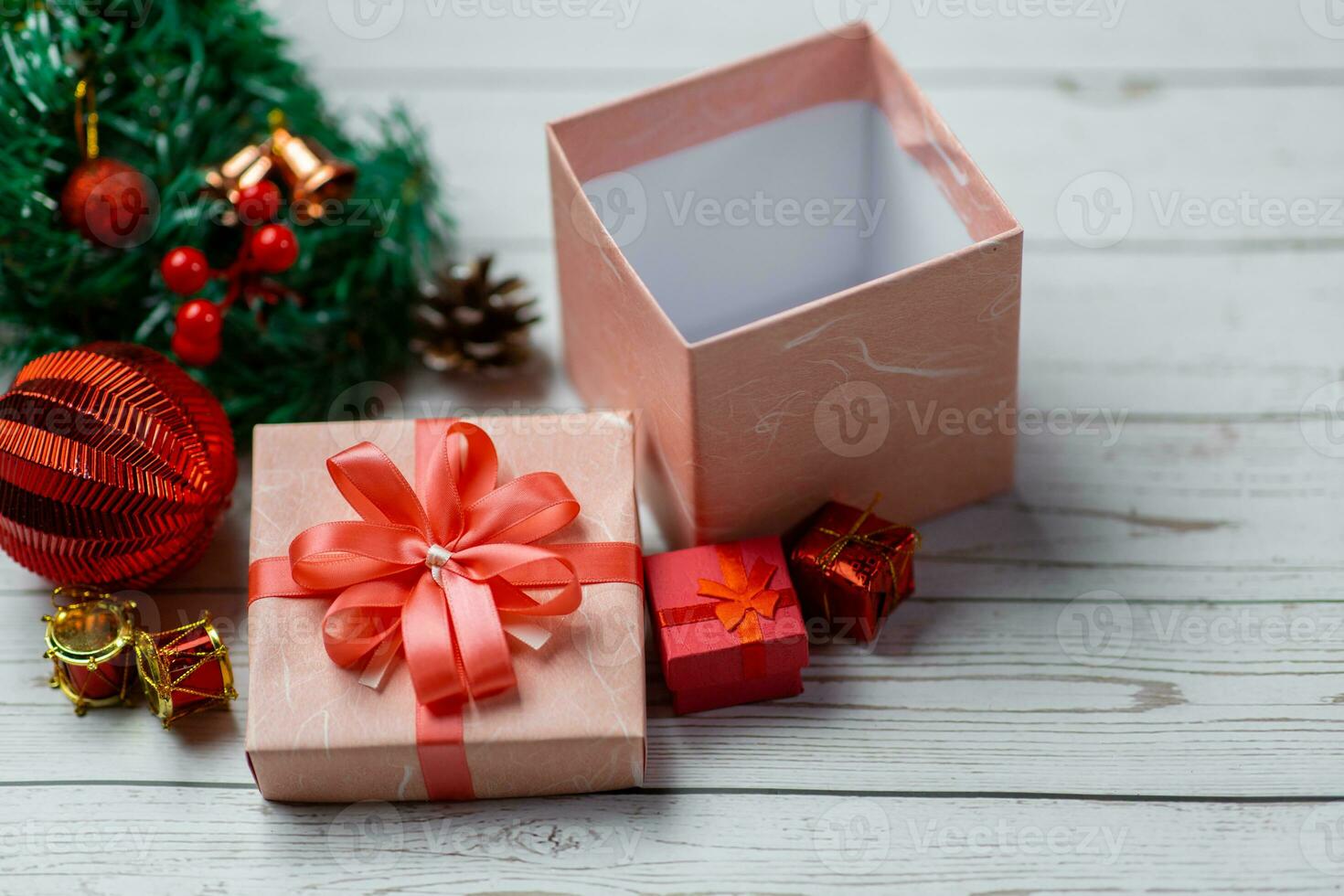 Closeup of pink gift box and Christmas composition on a wood background. Layout Christmas background concept. photo