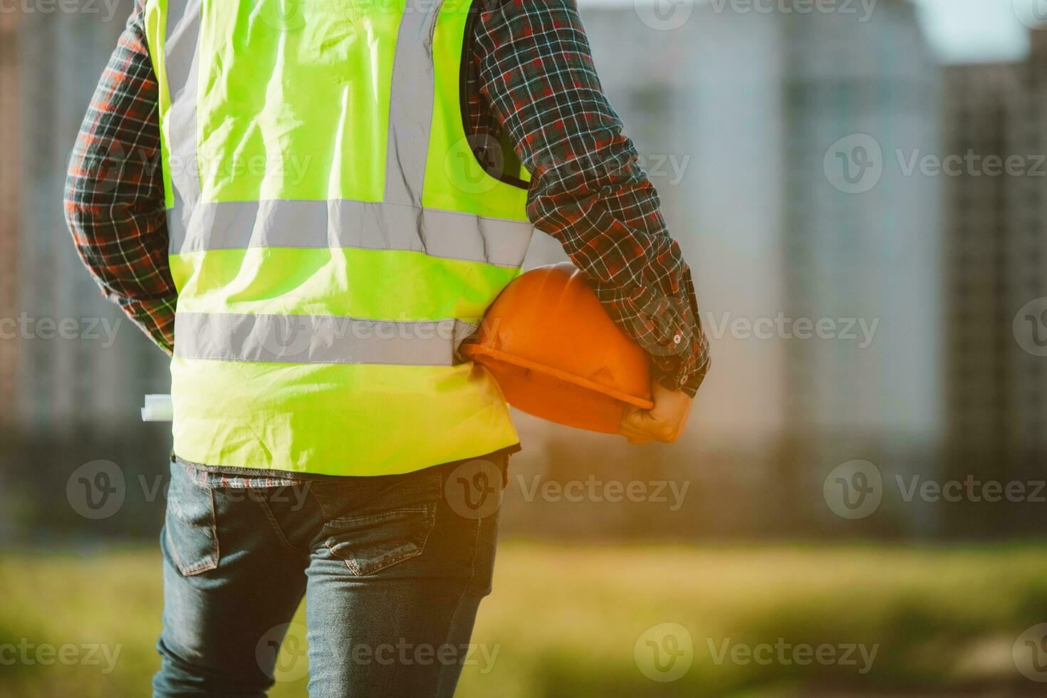 Engineer male working or checking at construction building site photo