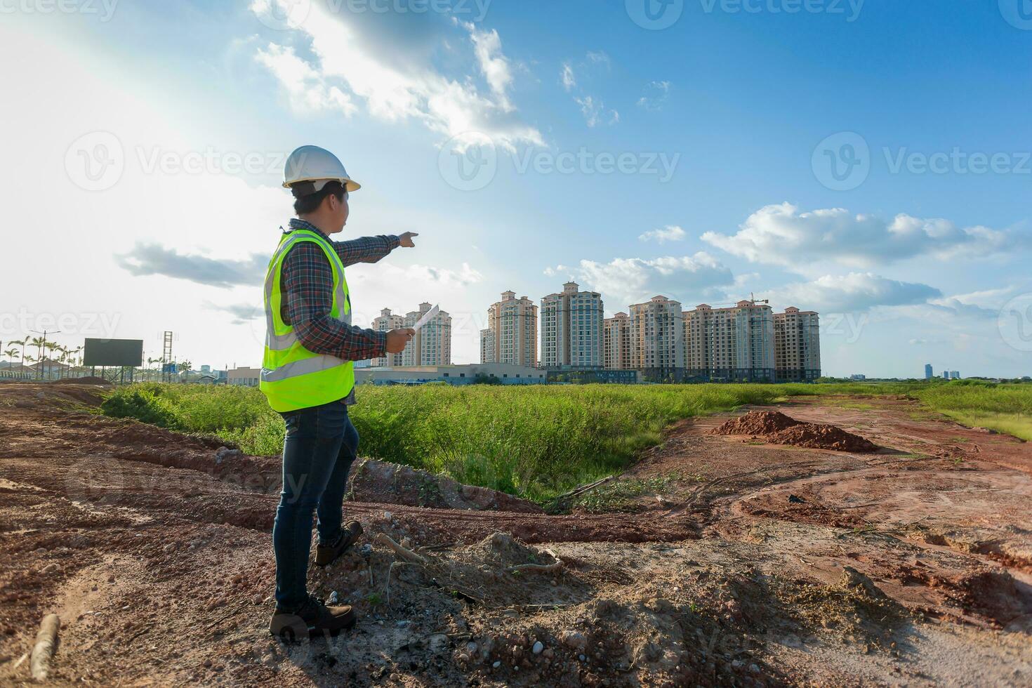 Engineer male working or checking at construction building site photo