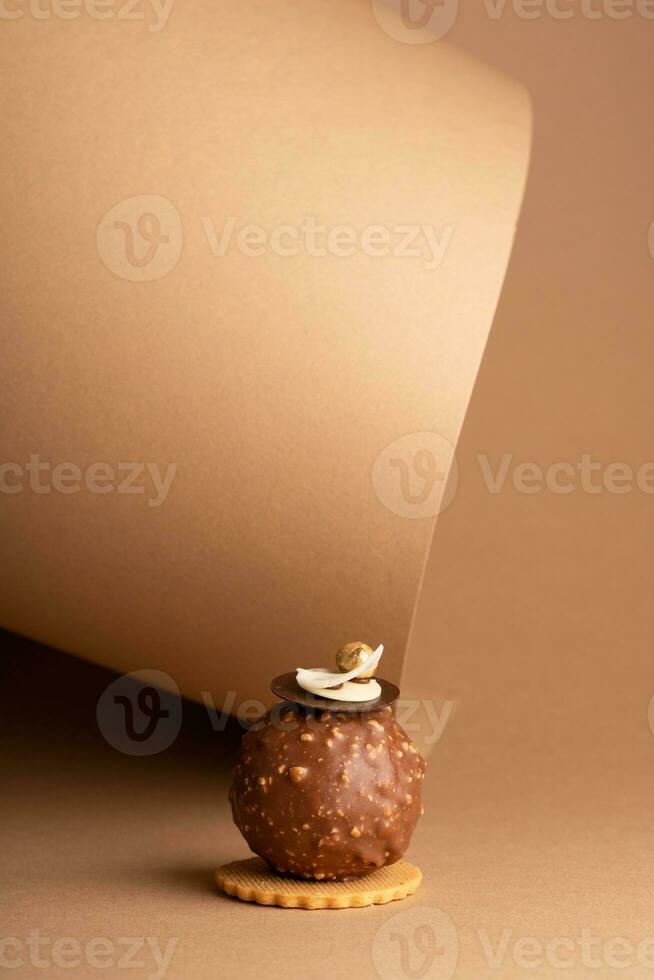 A decadent chocolate cake on a piece of parchment paper, ready to be enjoyed photo