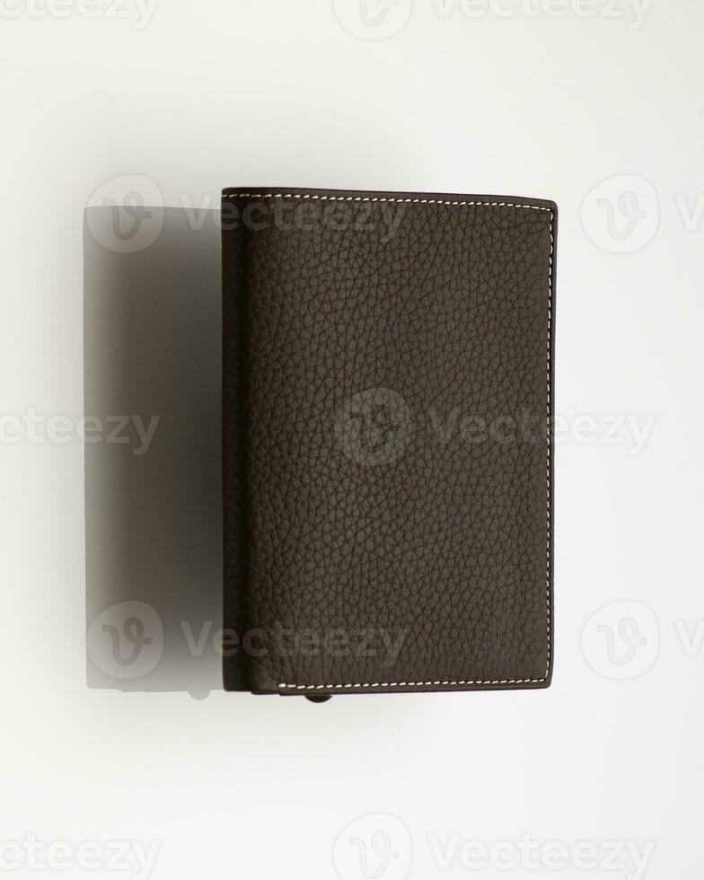 Close-up shot of a fashionable leather men's wallet on a white background with reflection photo