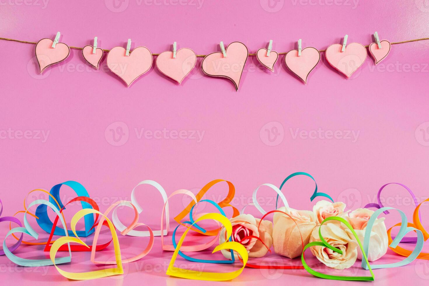 multicolored Love hearts and roses on pink background. photo