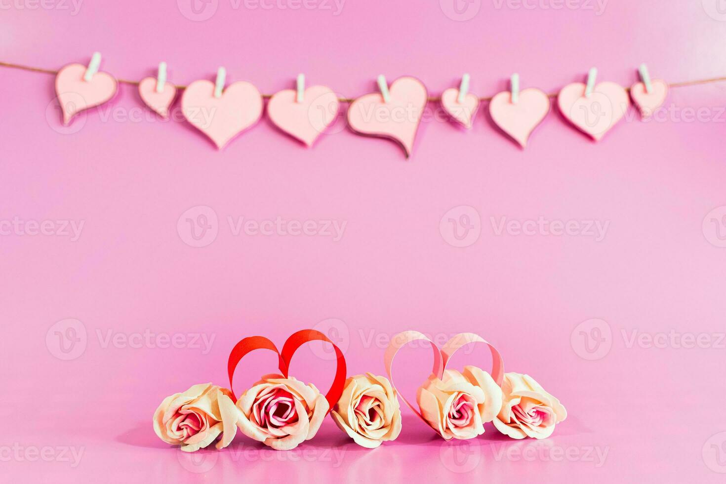 Love hearts and roses on pink background. photo