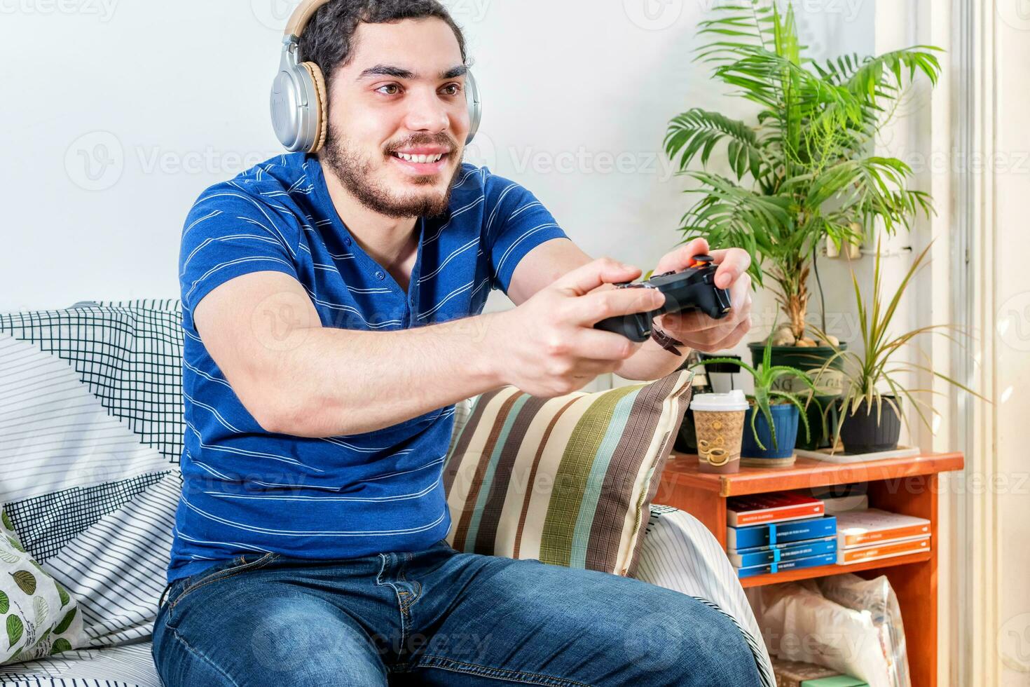 view of a happy young man playing the game photo