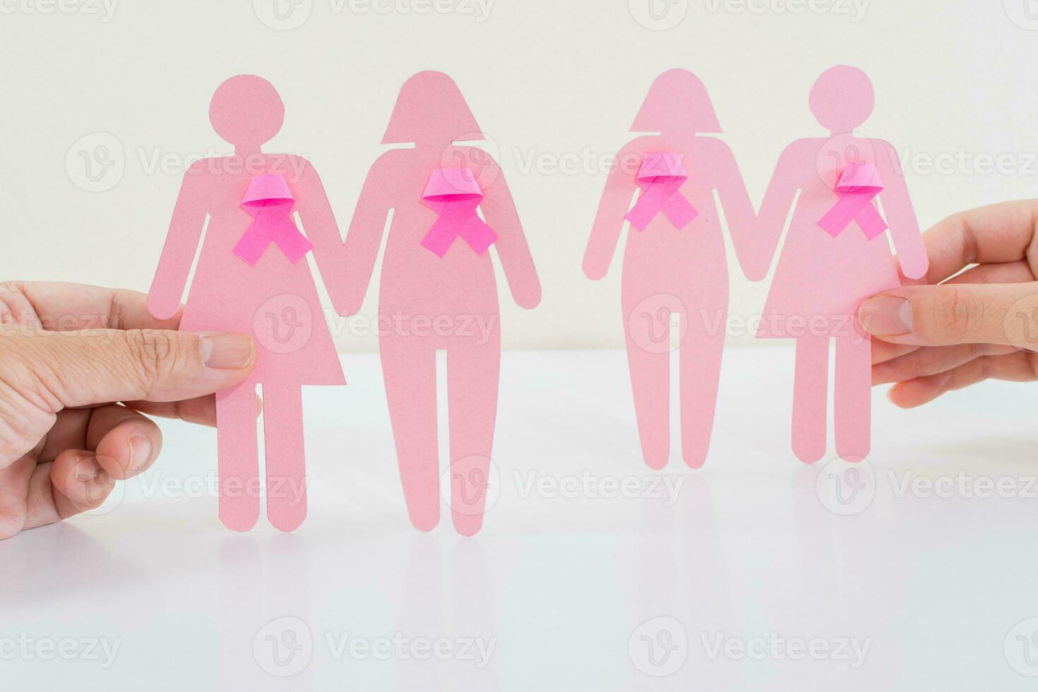 Breast Cancer Awareness, paper girl silhouettes and pink ribbon symbol. photo