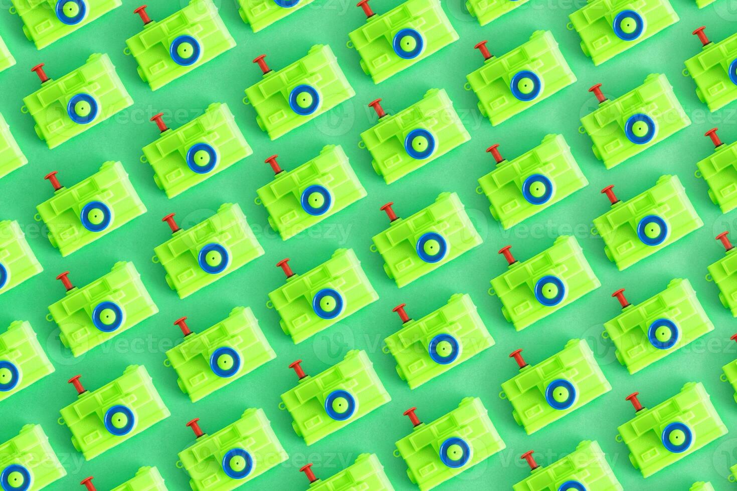 Pattern, Isolated toy camera, green color, on green background. Top view. photo