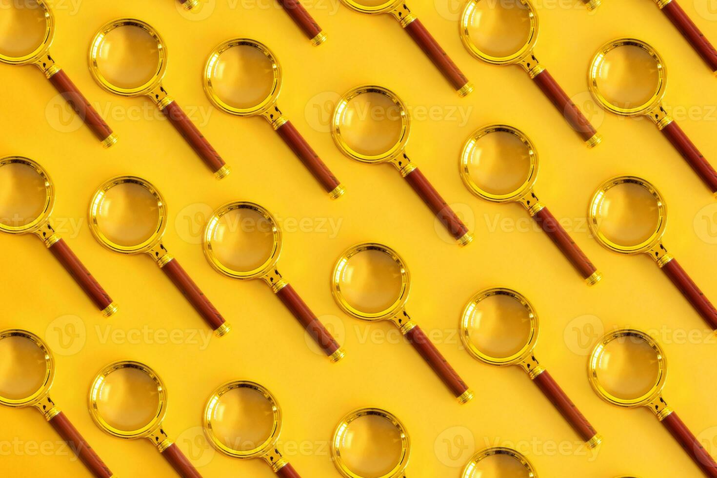 Top view of a magnifying glass, on a pastel yellow background. Space for your text. photo
