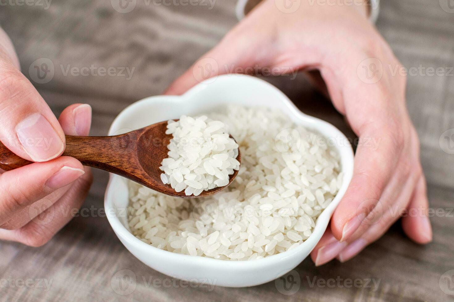 Close up of wooden spoon with rice grains. photo