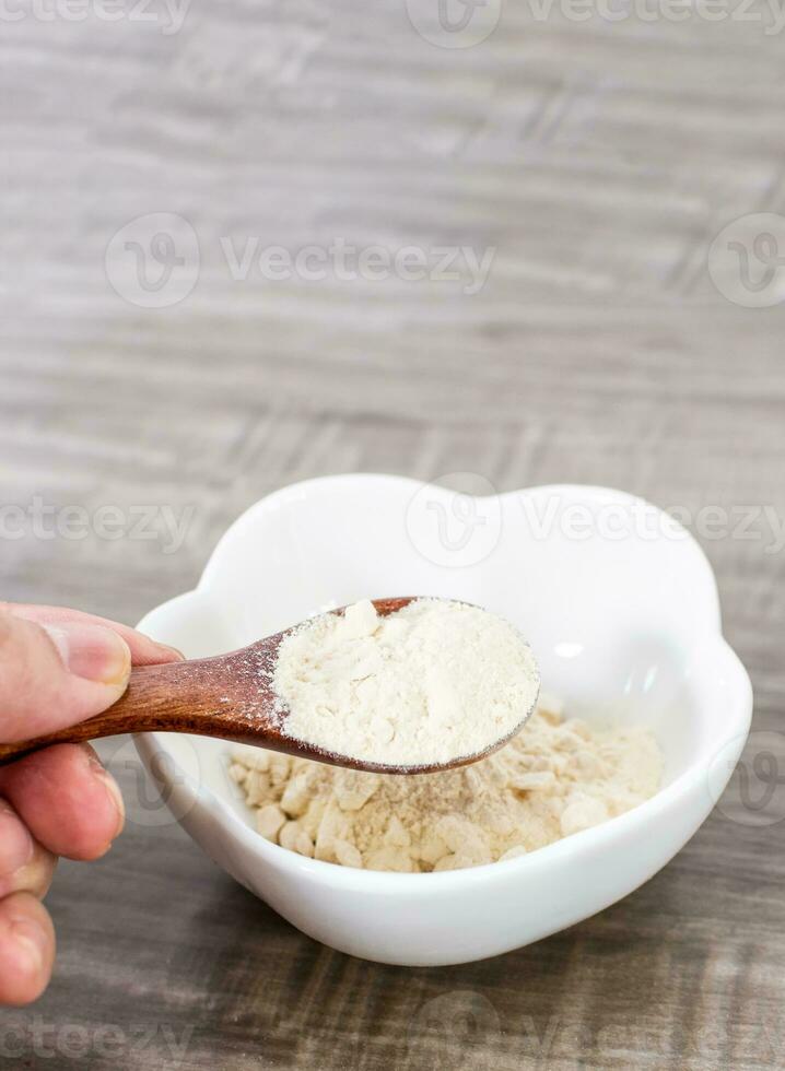 Close up of wooden spoon with garlic powder. photo
