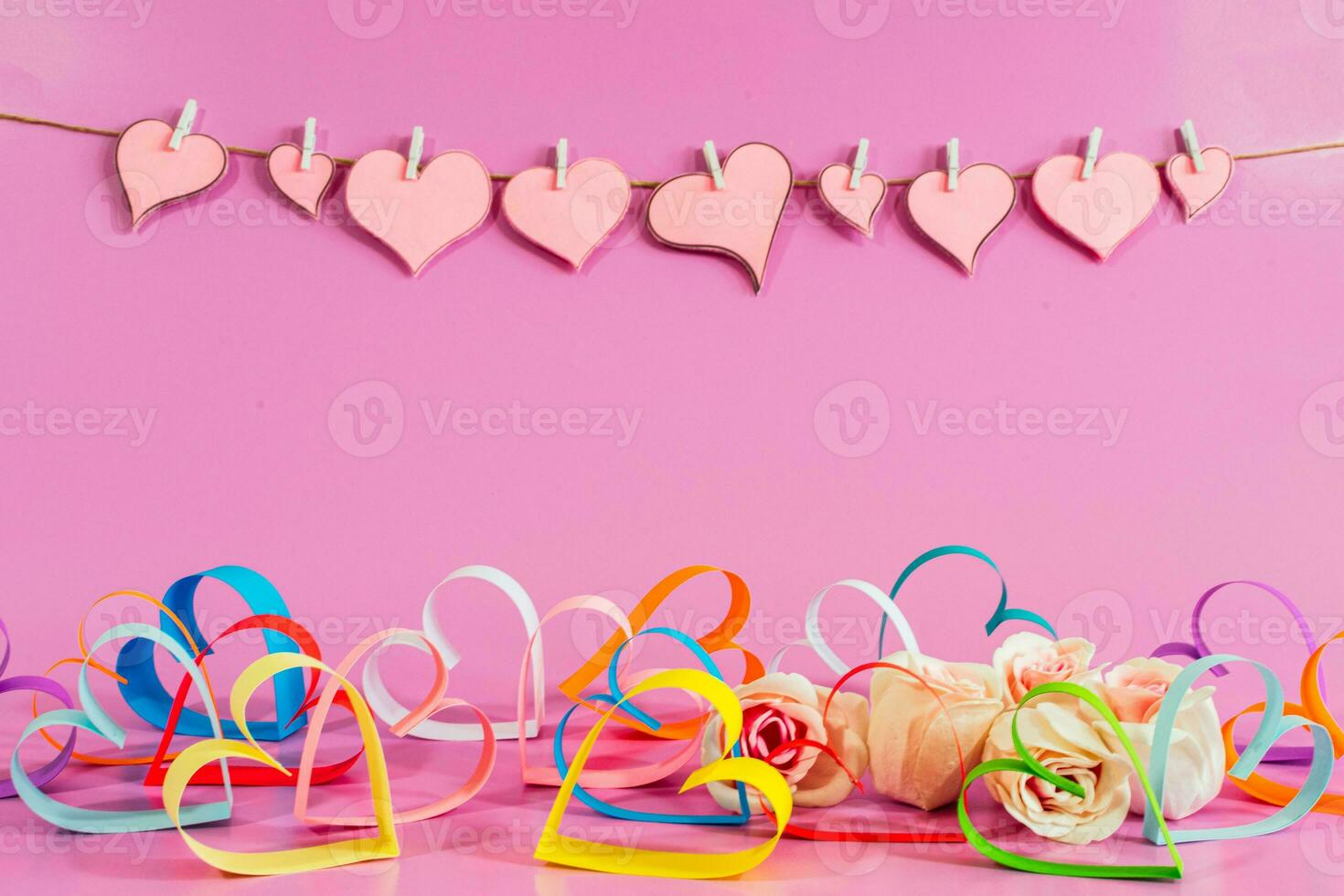 multicolored Love hearts and roses on pink background. photo