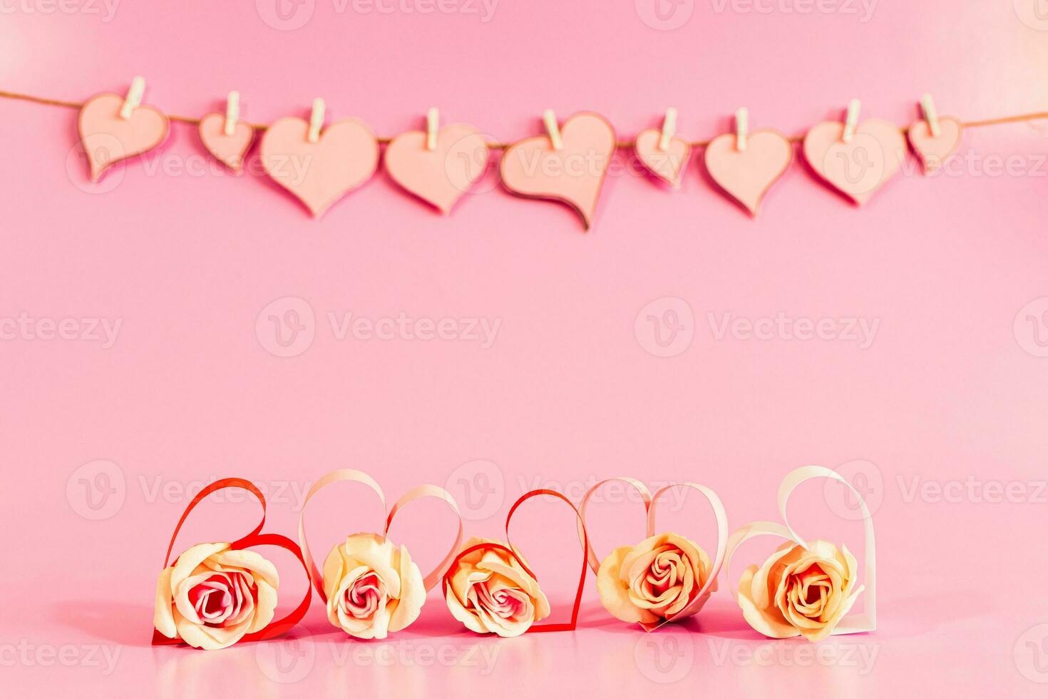 Love hearts and roses on pink background. photo