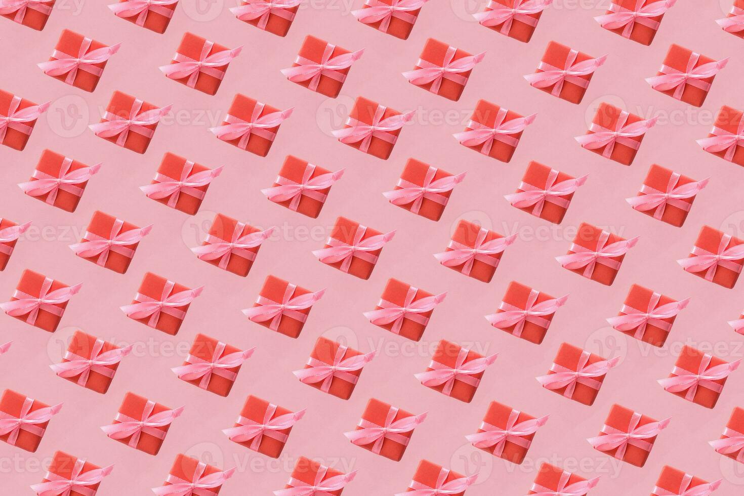 Pattern of craft boxes with pink ribbon bows. Valentine day concept. Minimalistic flat lay design background in pop art style. photo