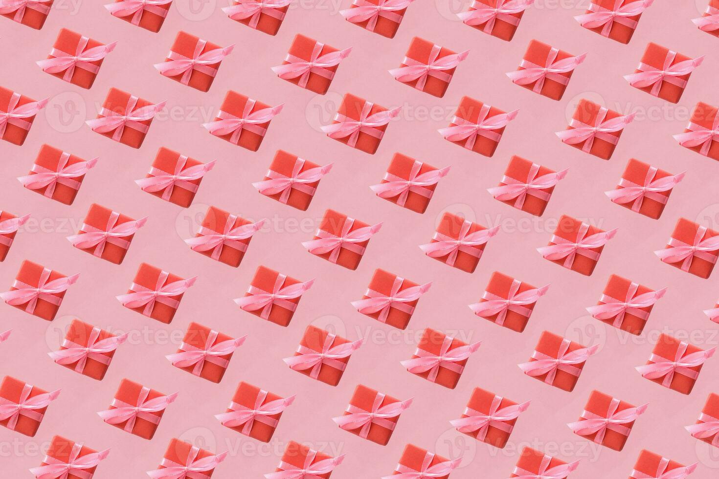Pattern of craft boxes with pink ribbon bows. Valentine day concept. Minimalistic flat lay design background in pop art style. photo