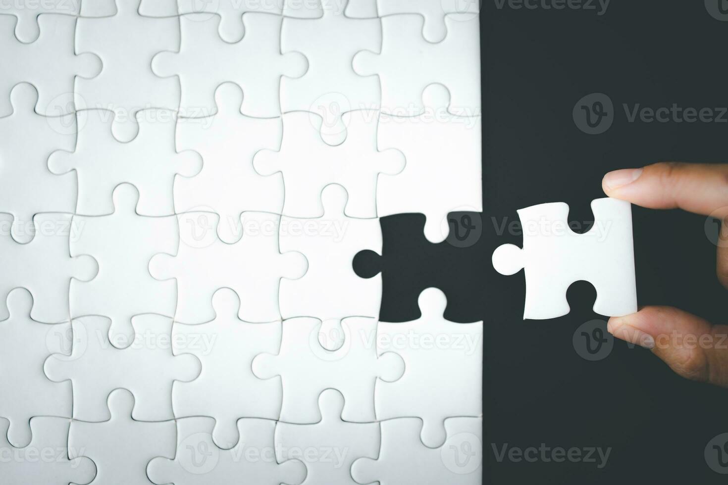 Concept of business, Hand put the last piece of jigsaw puzzle to complete the mission. photo
