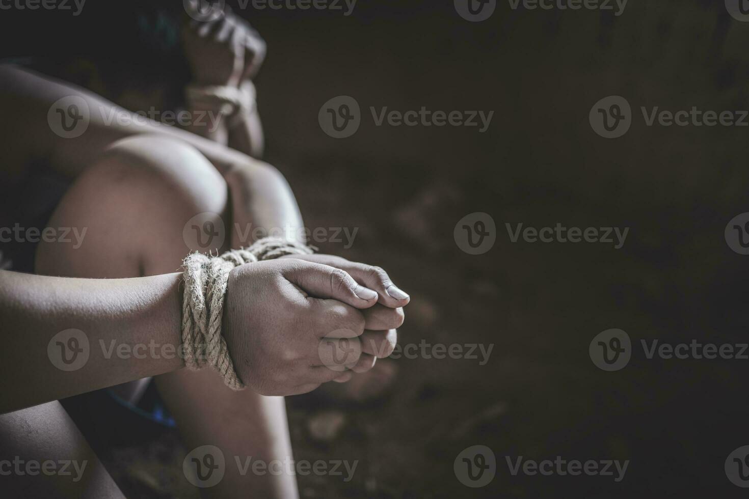 Hands of a missing kidnapped, abused, hostage, victim woman tied up with rope in emotional stress and pain, Human trafficking ,Stop abusing violence. photo