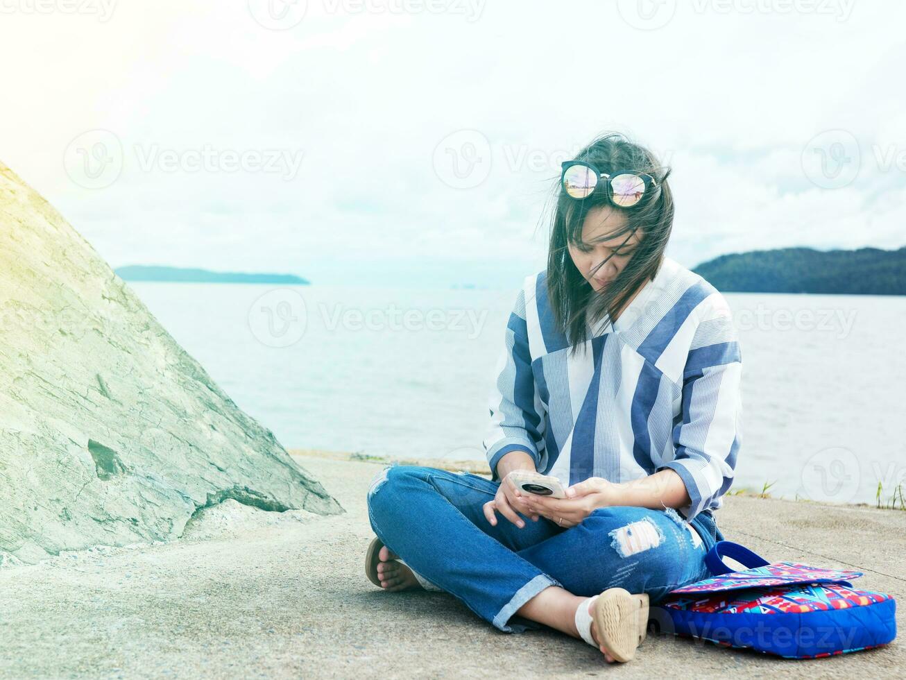 woman sit with her suitcase luggage on beautiful  sea view on sunny day joy nature, sea, back view photo