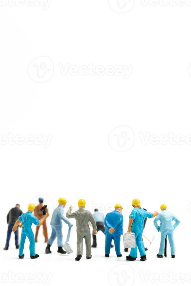 Miniature people , Worker team standing on white background, Labour day concept photo