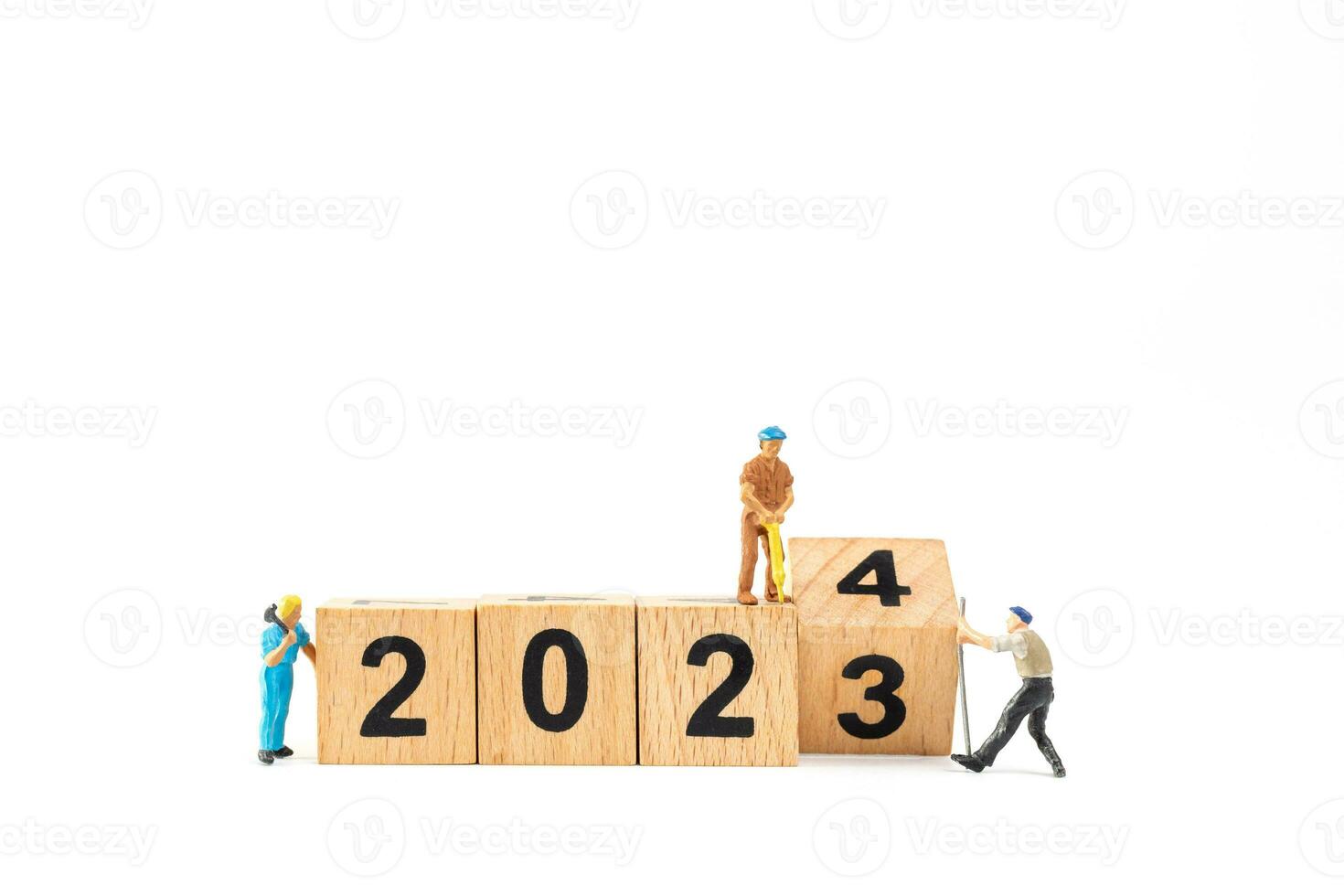 Miniature people , Worker team flips a wooden block with the number 2024 photo