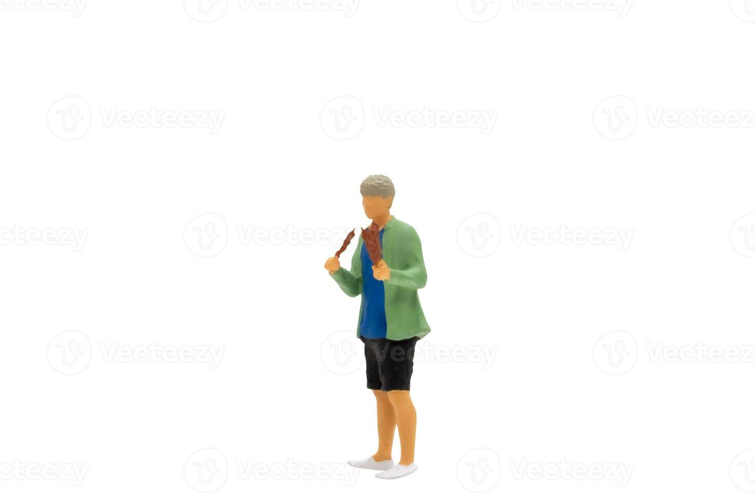 Miniature people Young man grilling BBQ photo