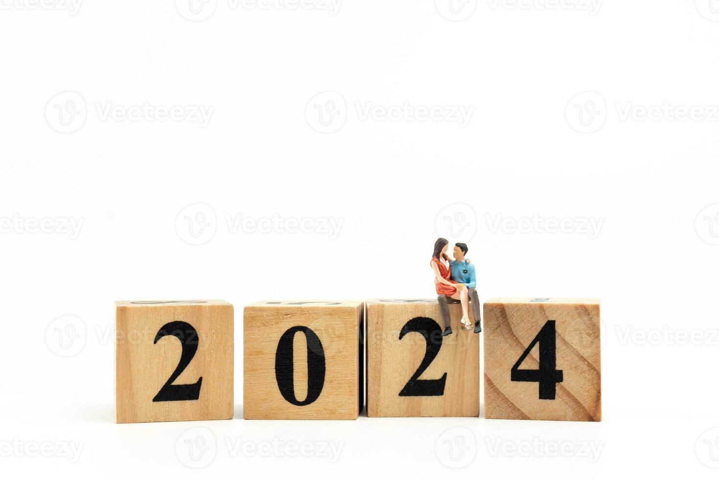 Miniature People Couple sitting On Wooden Block Number 2024 photo