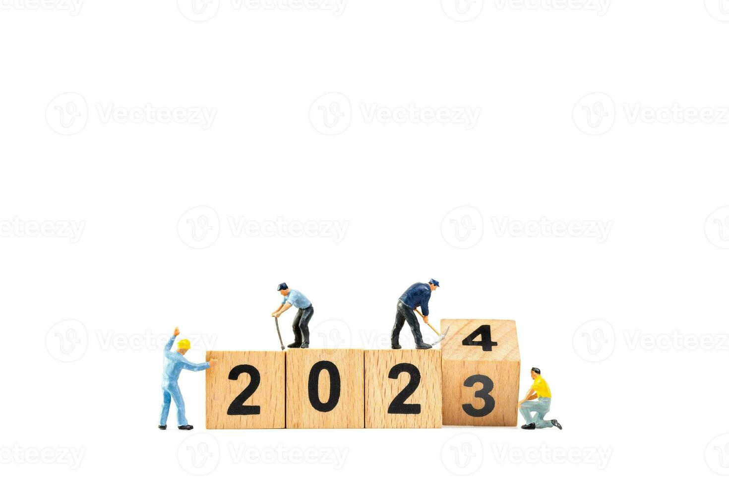 Miniature people , Worker team flips a wooden block with the number 2024 photo