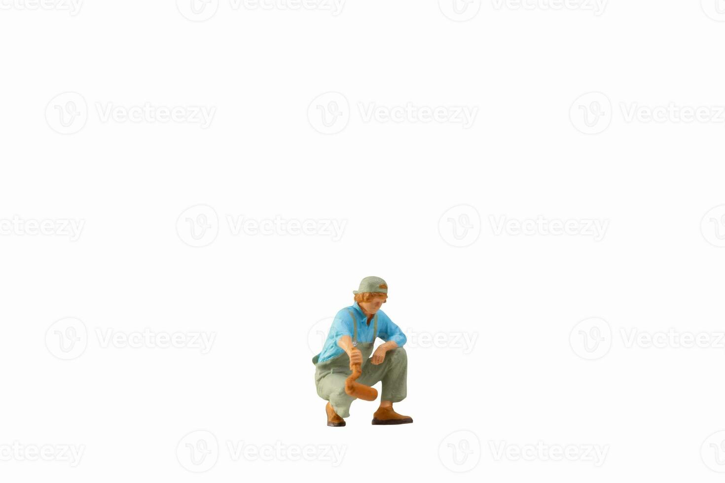 Miniature painter holding paint roller isolated on white background with clipping path photo