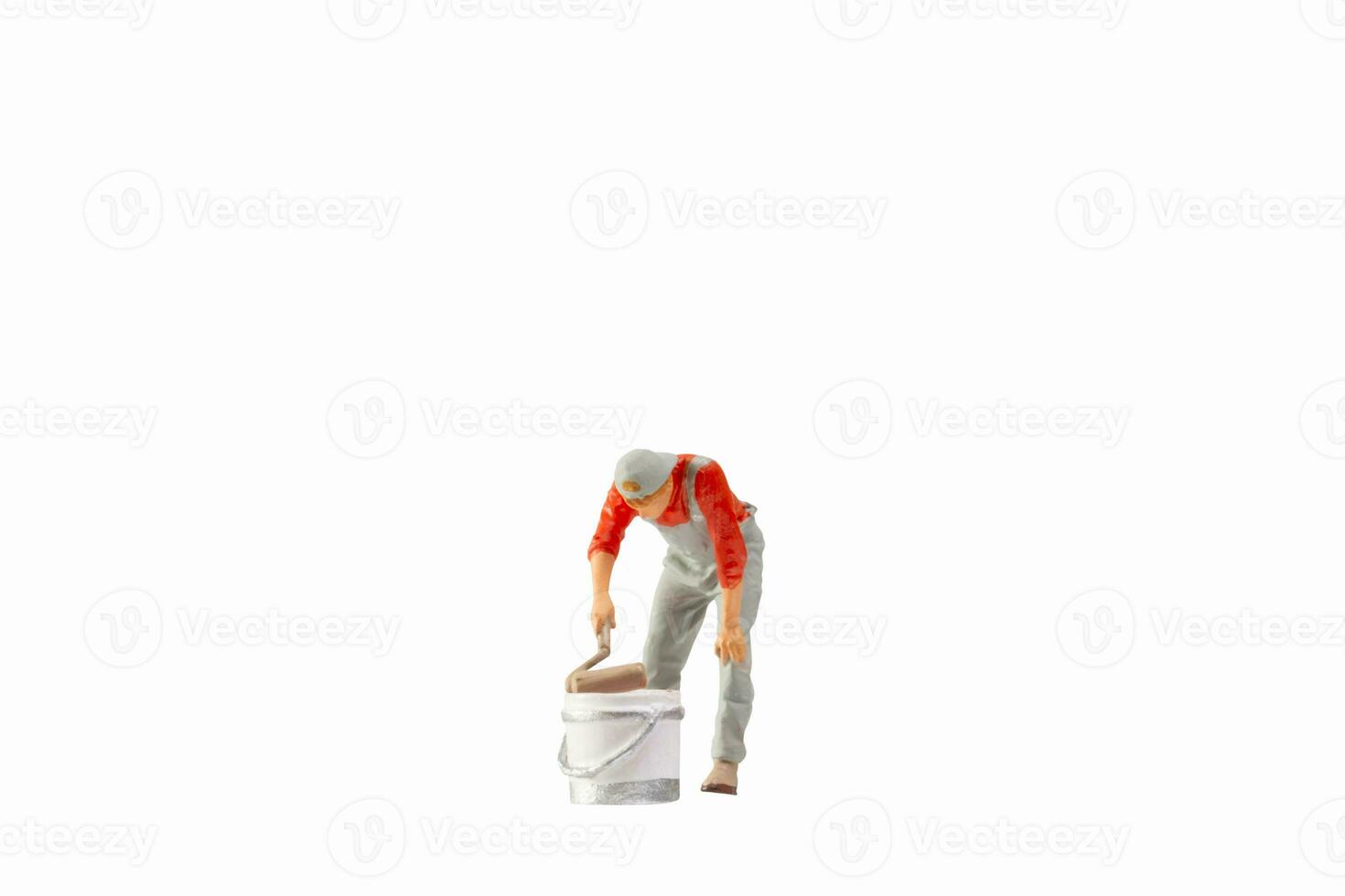 Miniature painter holding paint roller isolated on white background with clipping path photo