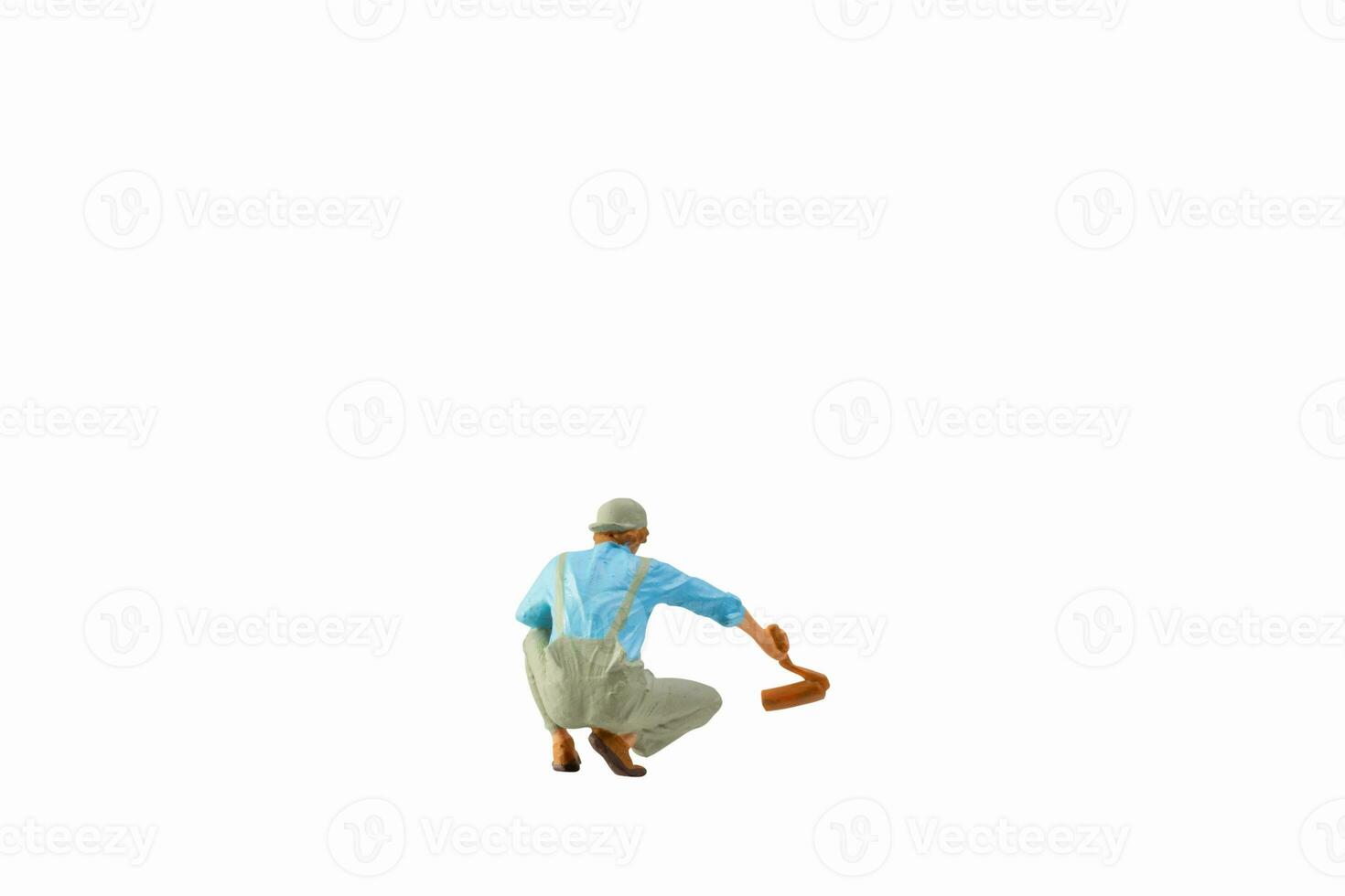 Miniature painter holding paint roller isolated on white background with clipping path photo