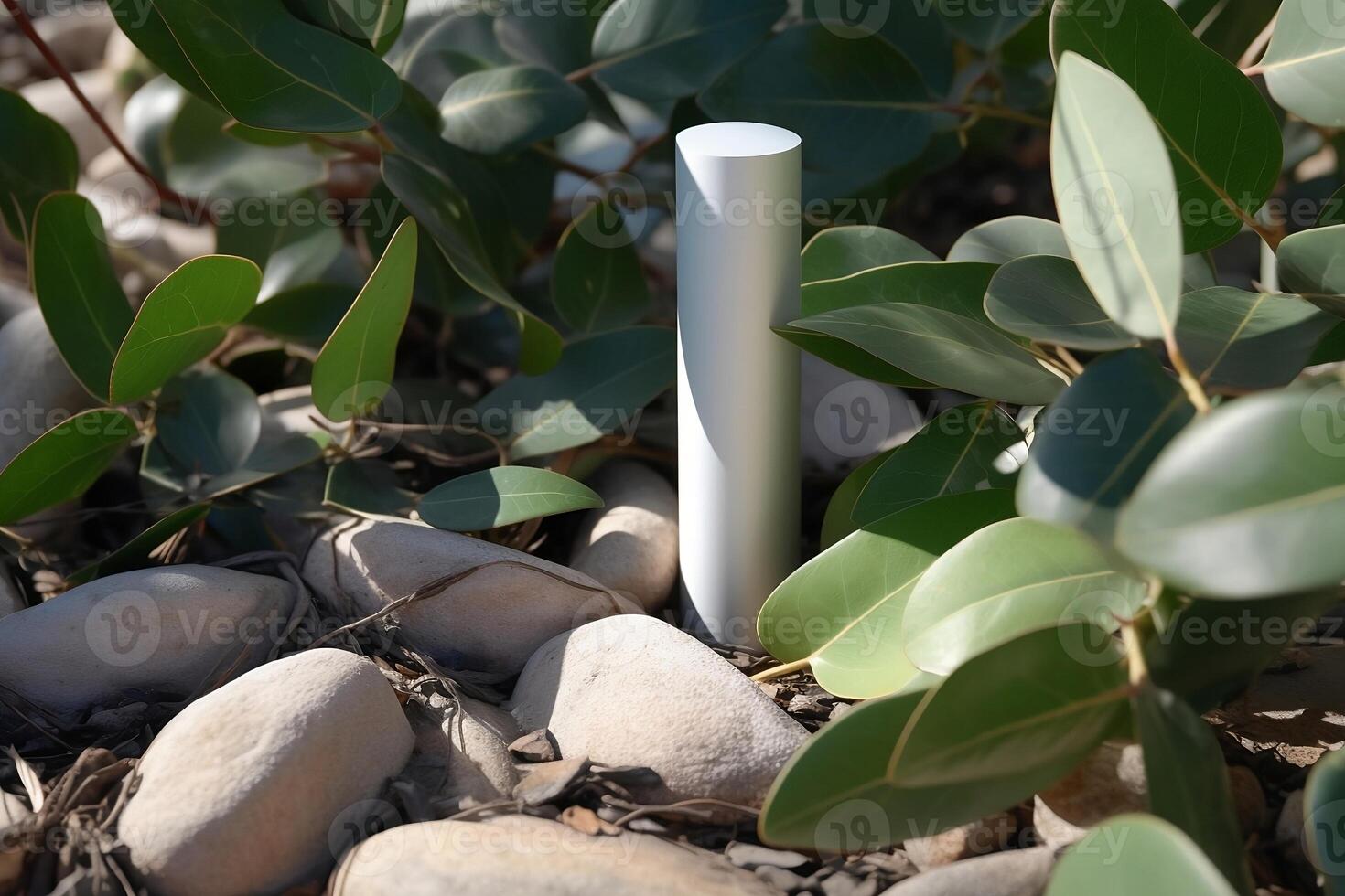 A mock-up of a tube of white cream with a lid on a background of eucalyptus leaves and stones. photo