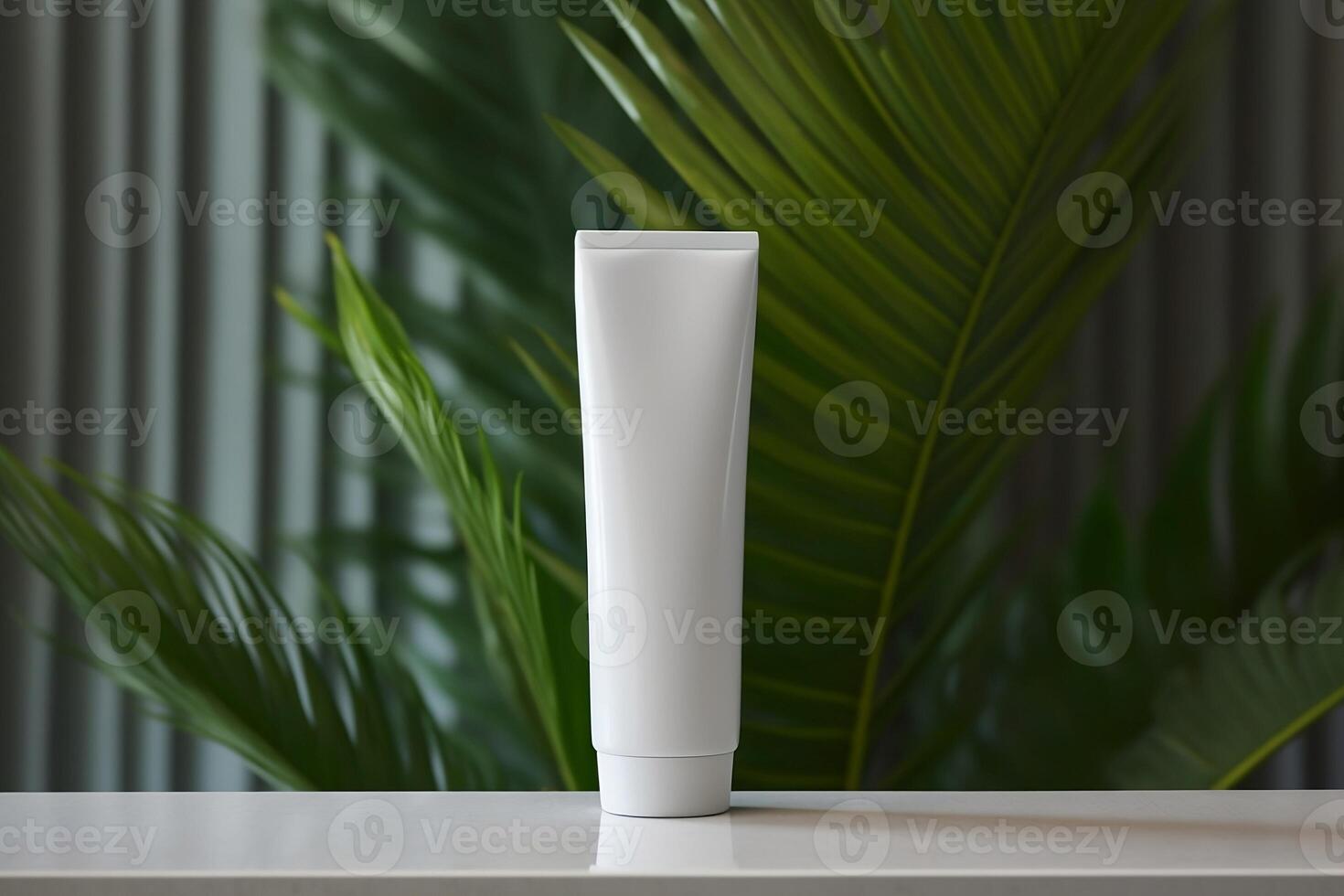 A mock-up white tube for cream on the background of palm leaves. photo