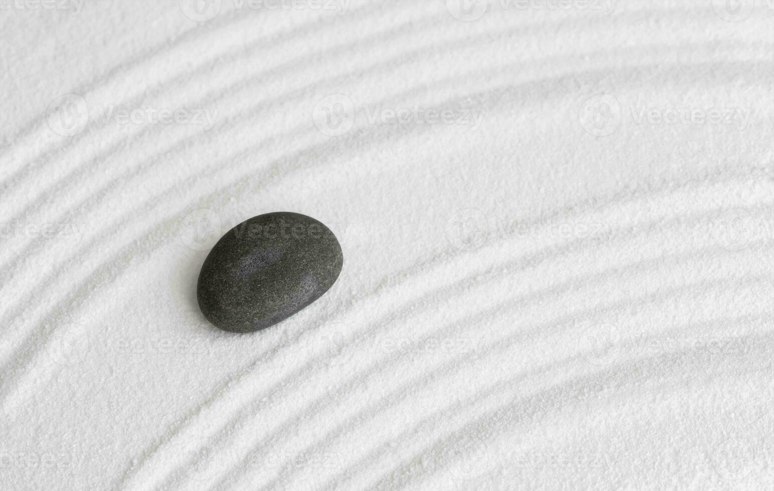 Zen Garden with Grey stone on White Sand Wave Pattern in Japanese stye, Rock Sea Stone on Sand texture with the wave parallel lines pattern,Harmony,Meditation,Zen like concept photo