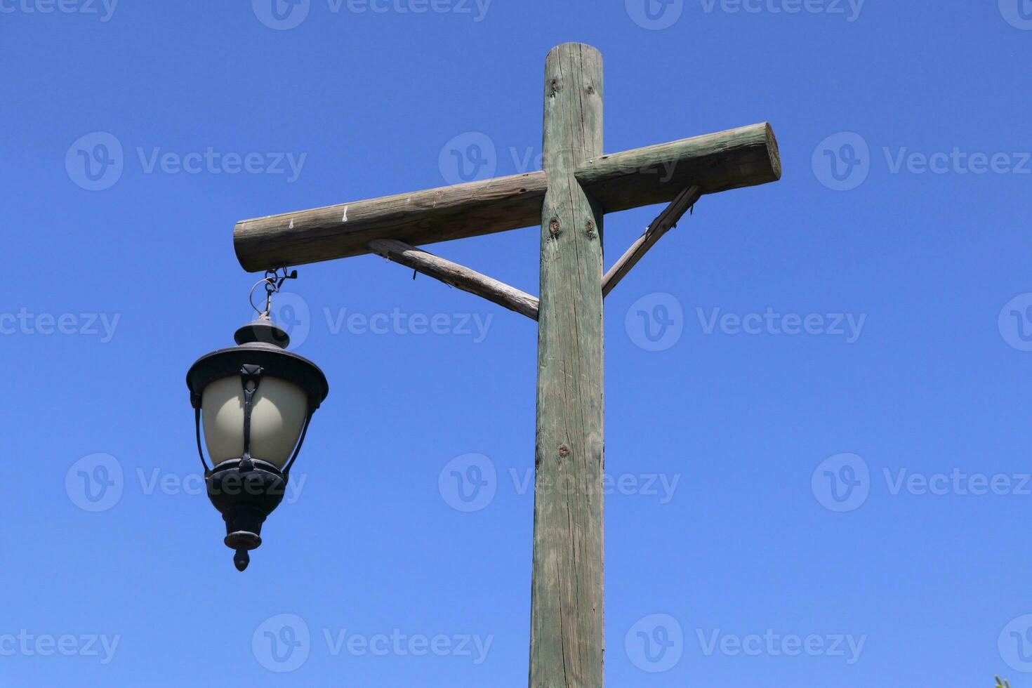 Old wooden lanterns hanging on a wooden pole. photo