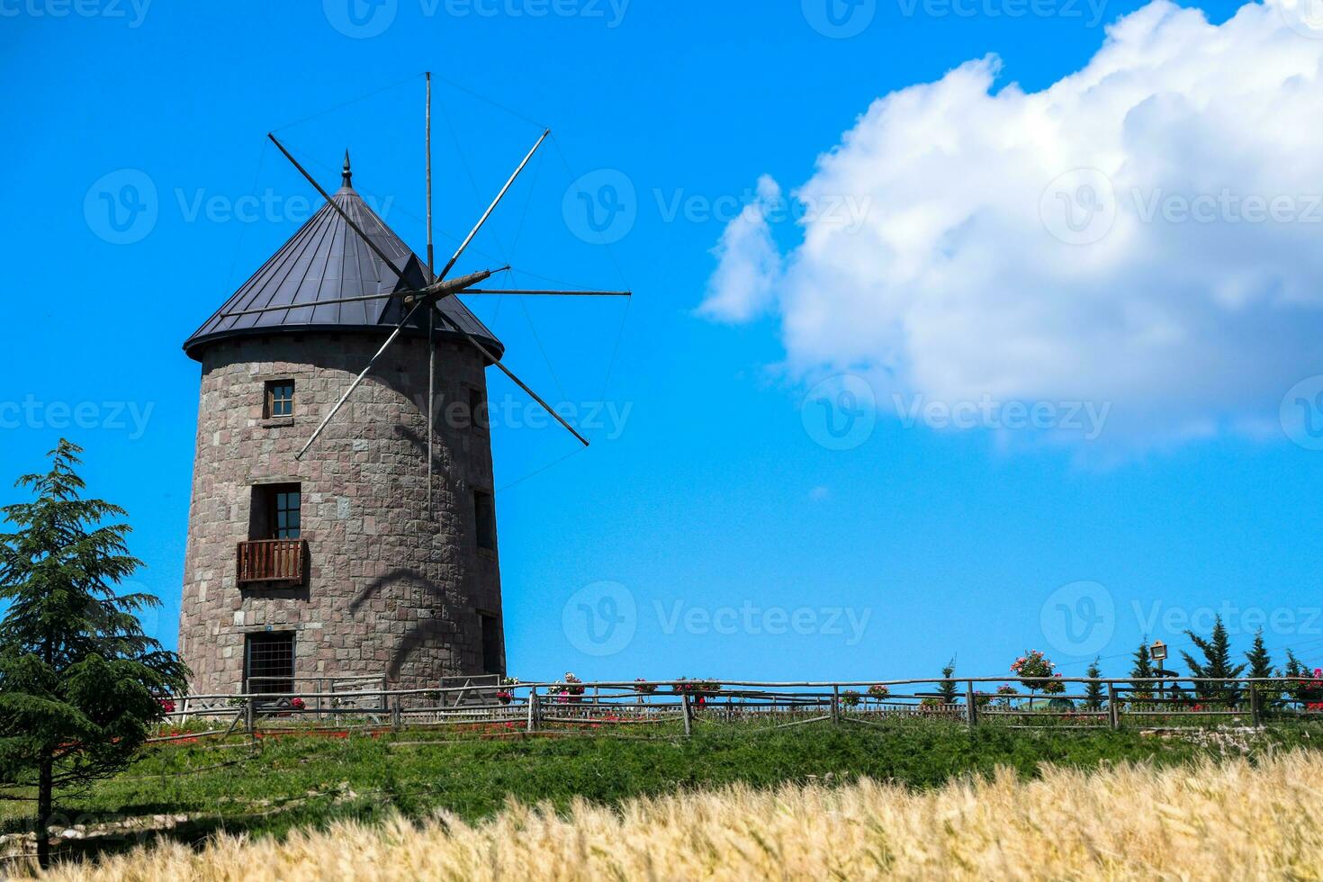Windmill and blue sky. Photo of windmill with harvests
