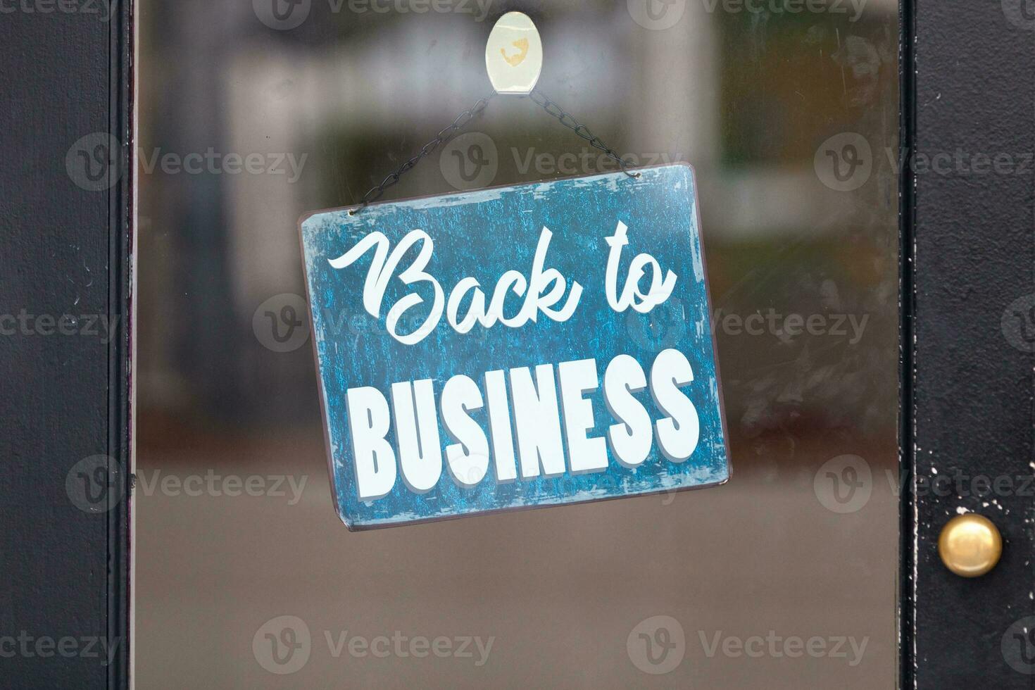 Back to business sign in a window photo