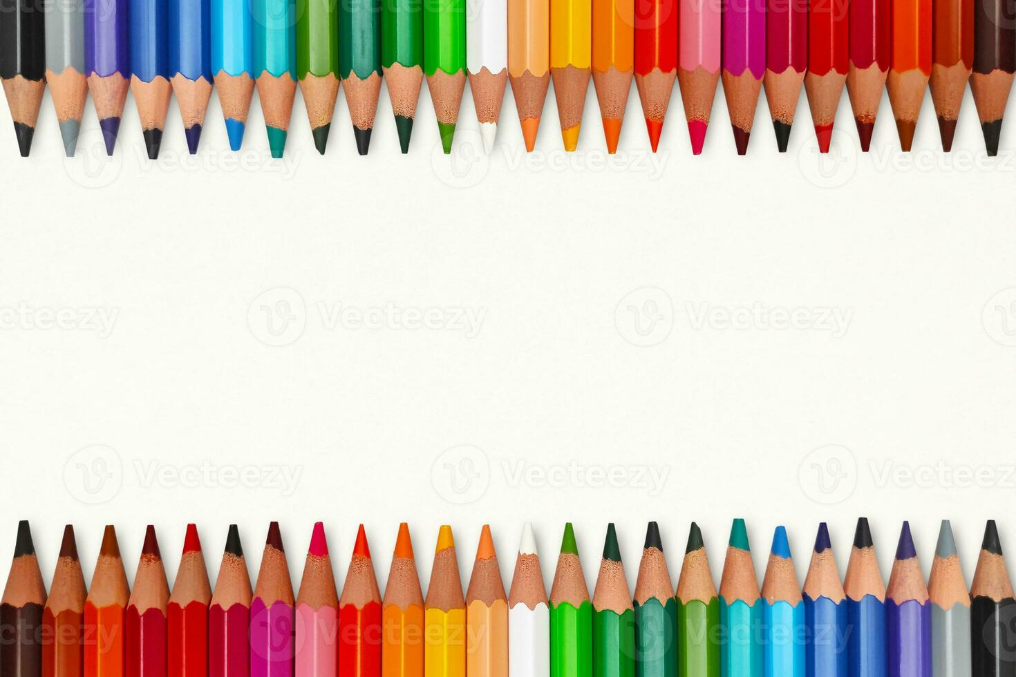 Tow rows of colorful crayons in line with copy space photo