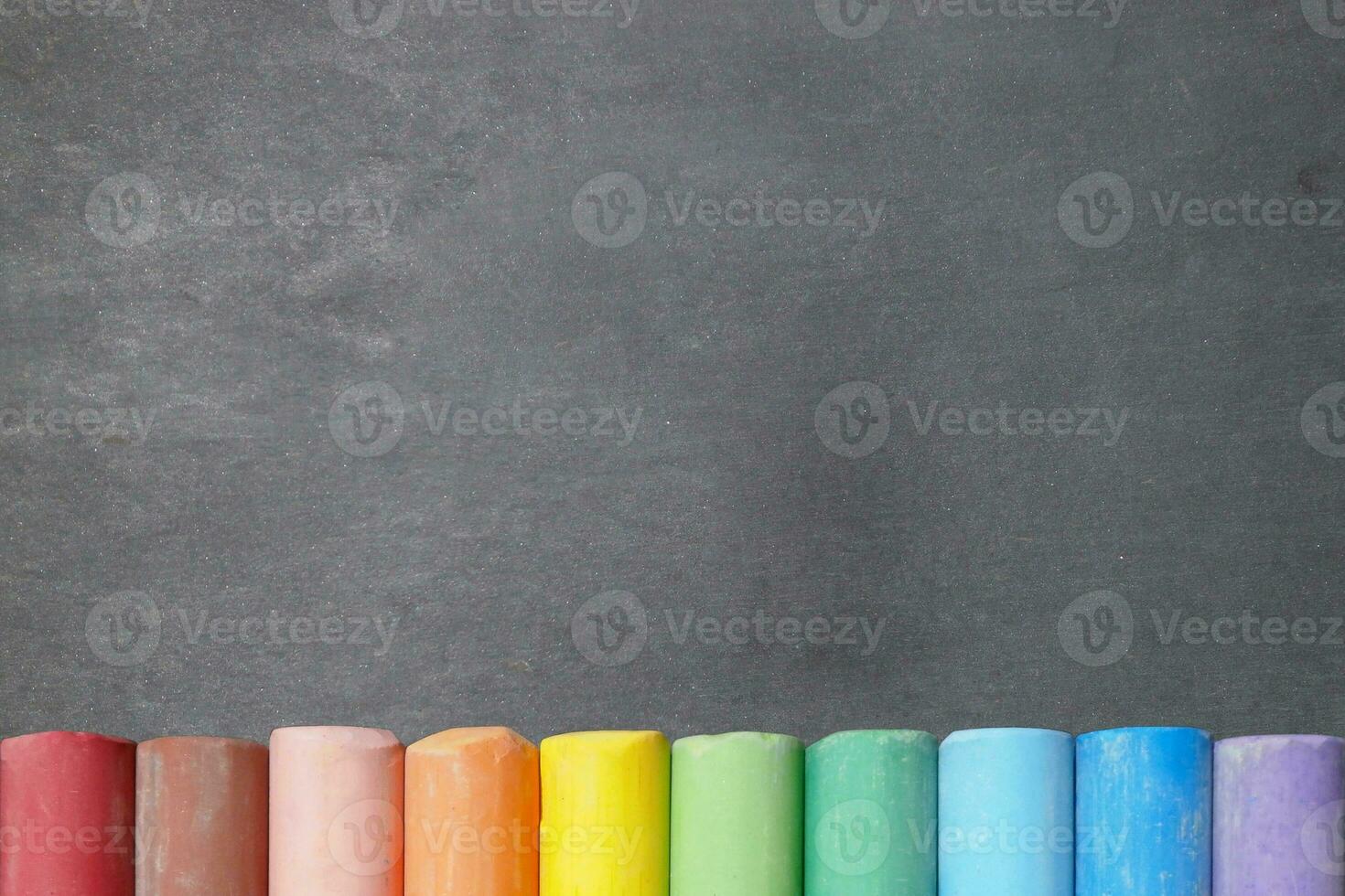 Blackboard with colorful chalk sticks photo