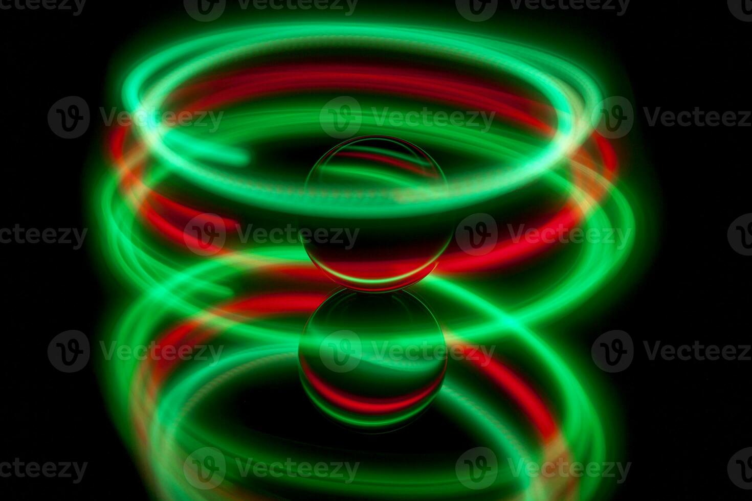 Abstract light painting circling around a glass ball photo