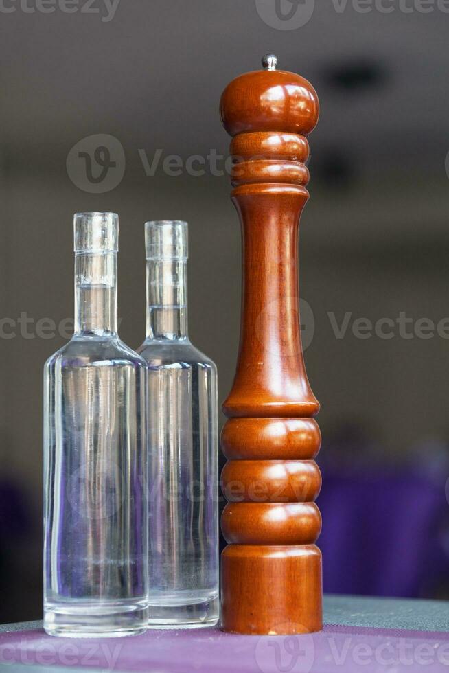 Pepper grinder and two bottles of water photo