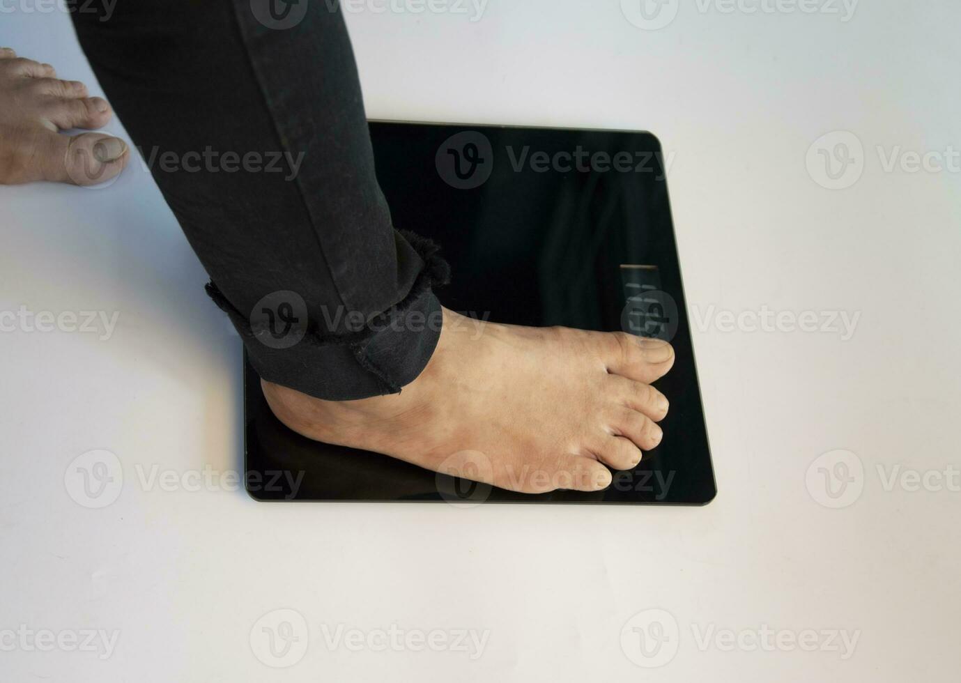 standing on the indoor scales There is space for text. The problem of being overweight or underweight photo