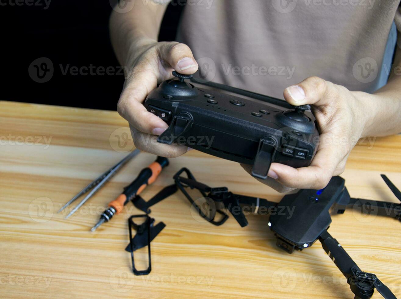 Professional mechanic repairing a drone, setting it up, on a table with various tools. in modern workshop photo