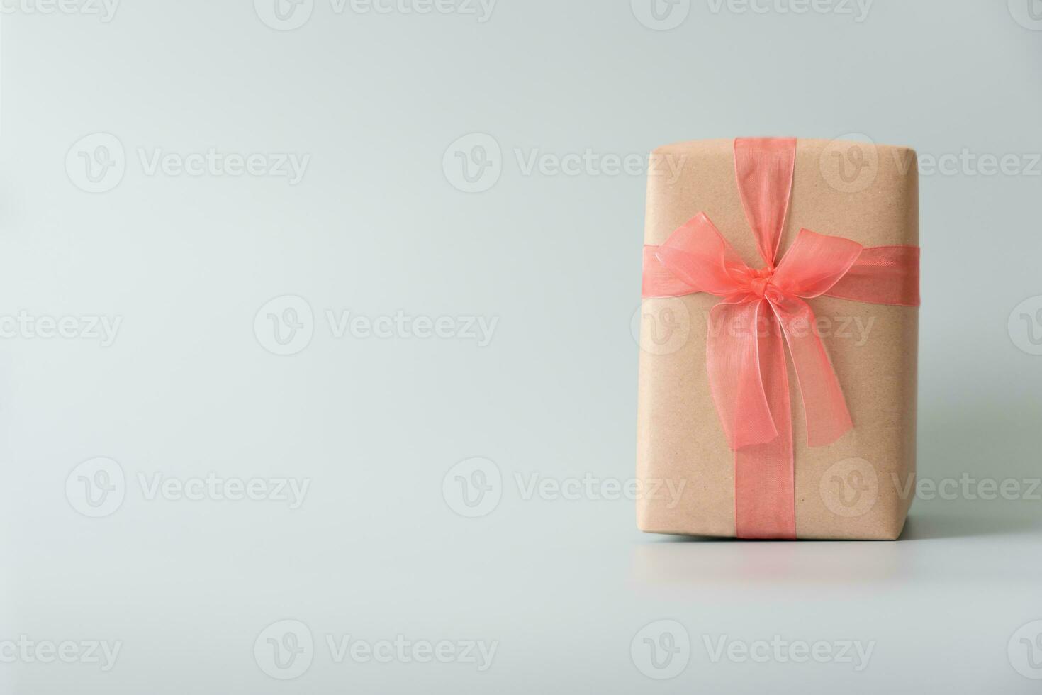 Woman carrying gift paper box tie cute ribbon for special occasion. Delivery sending present to someone special to thank or surprise. photo