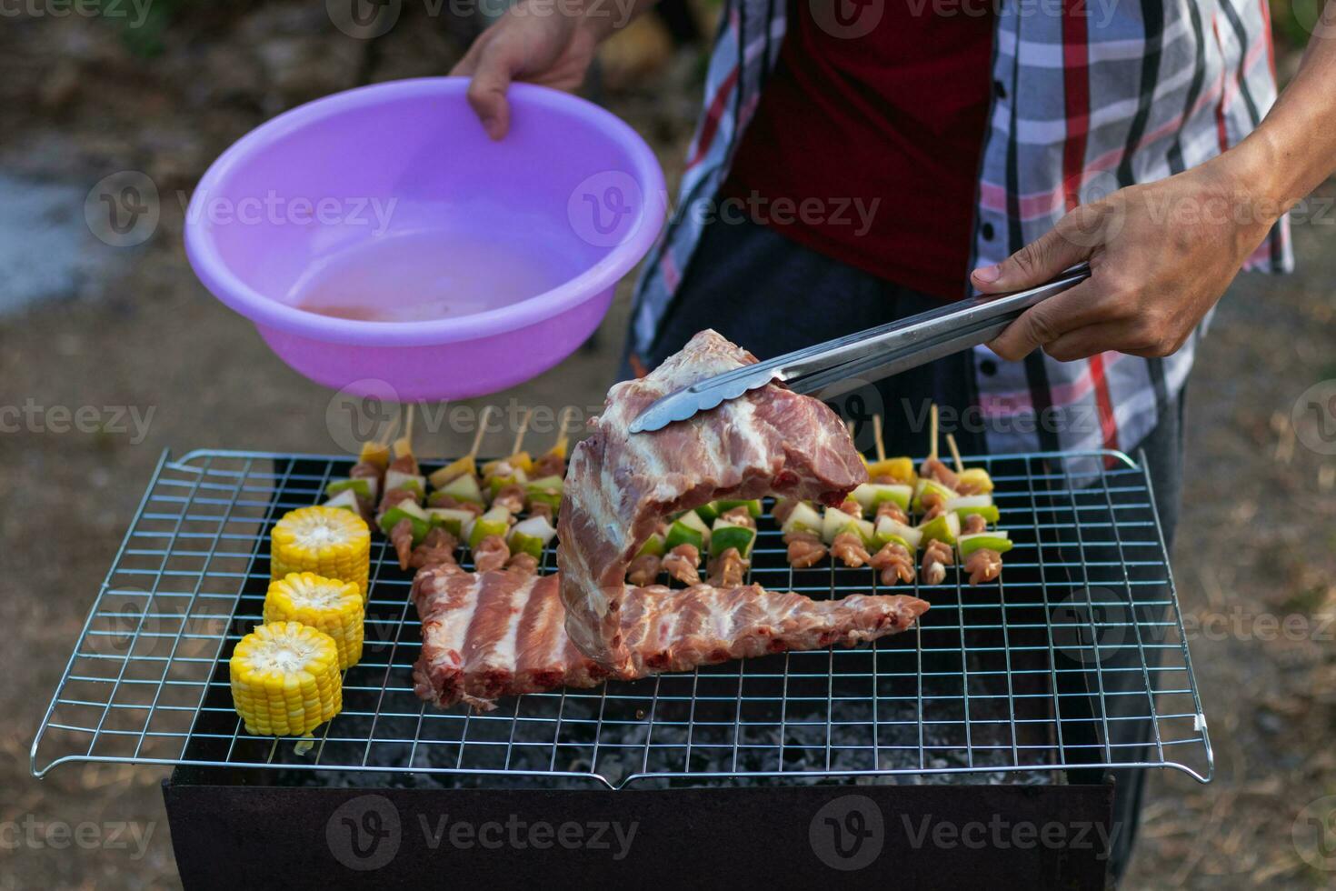 Meat and skewers ingredients for barbecue party are placed on grill to cook barbecue and make it ready for family to join barbecue party tonight.  party background image has Copy Space for text. photo