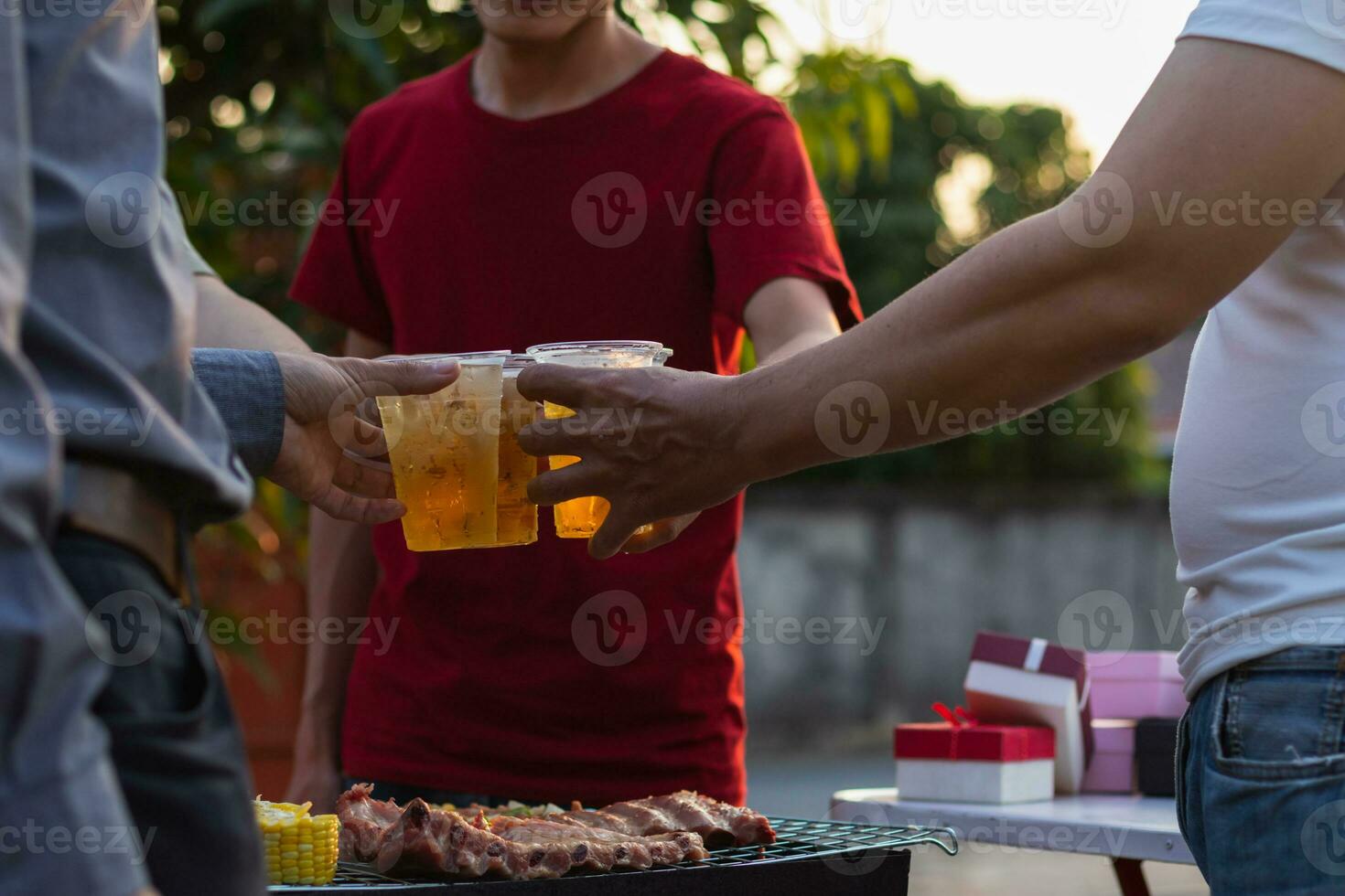 Beer drinks prepared for barbecue party among friends are served in plastic glasses because plastic glasses can be easily stored at end of party. Easy party idea by serving beer in plastic glasses. photo