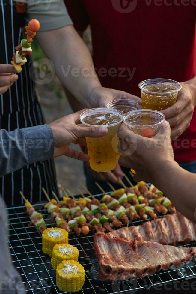 Beer drinks prepared for barbecue party among friends are served in plastic glasses because plastic glasses can be easily stored at end of party. Easy party idea by serving beer in plastic glasses. photo